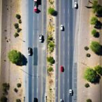 an aerial view of a highway with cars driving on it