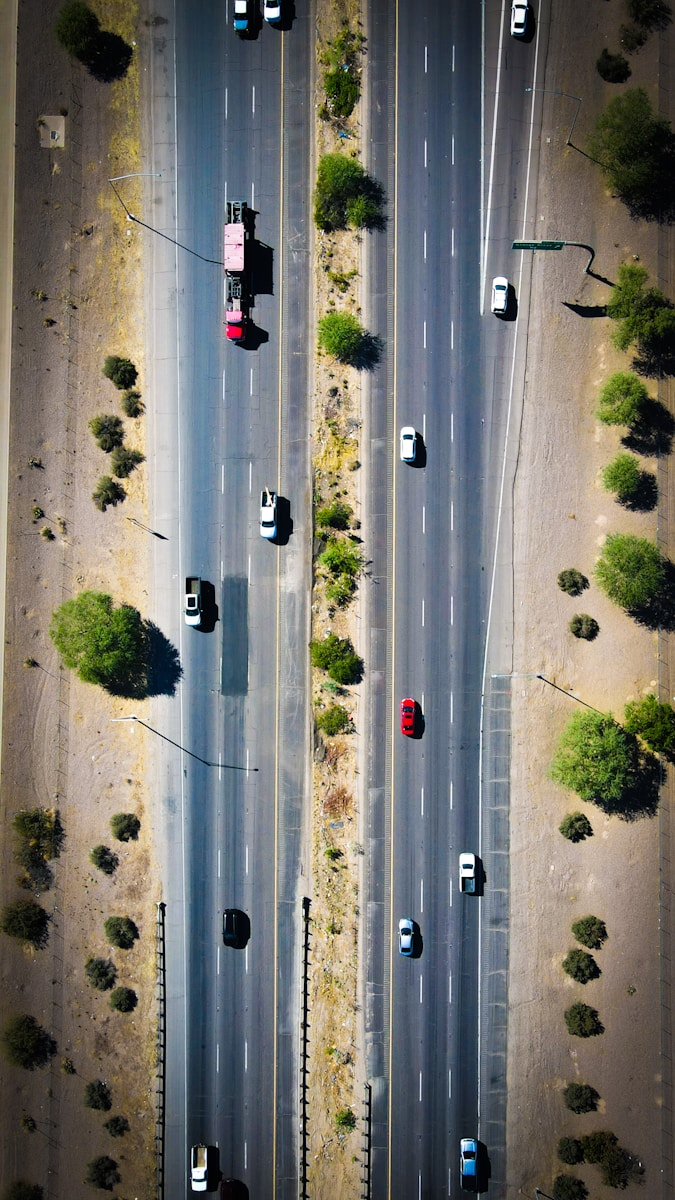 an aerial view of a highway with cars driving on it