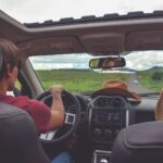 man driving straight on pathway during day time