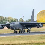 a large military plane on a run way
