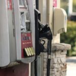 a gas pump next to a brick wall
