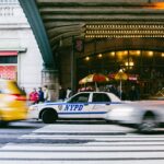 time-lapse photography of NYPD police car at pedestrian lane