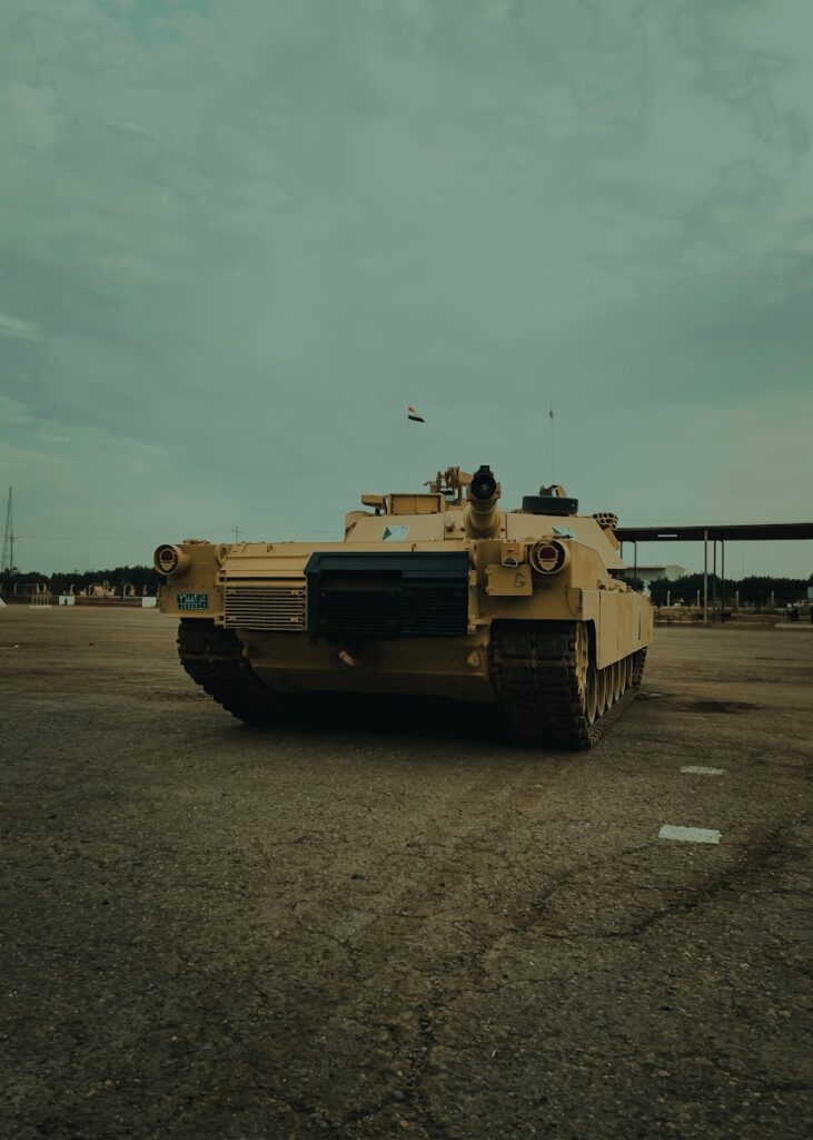 a yellow tank sitting in a parking lot