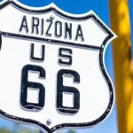 a close up of a street sign with a sky background