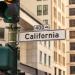 Street sign for california with traffic light.