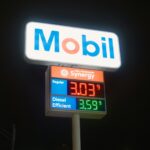 Mobil gas station sign with fuel prices at night